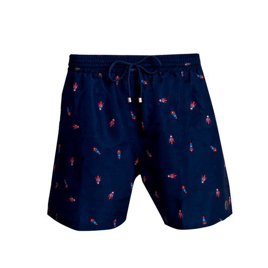 Bañador de hombre clásico con goma en la cintura, azul marino con estampado de cohetes. Bolsillos laterales y un bolsillo trasero con cremallera. Rápido secado. Classic cut swim shorts. Navy with rockets print. Two side pockets and one back pocket with zipper. Quick dry.