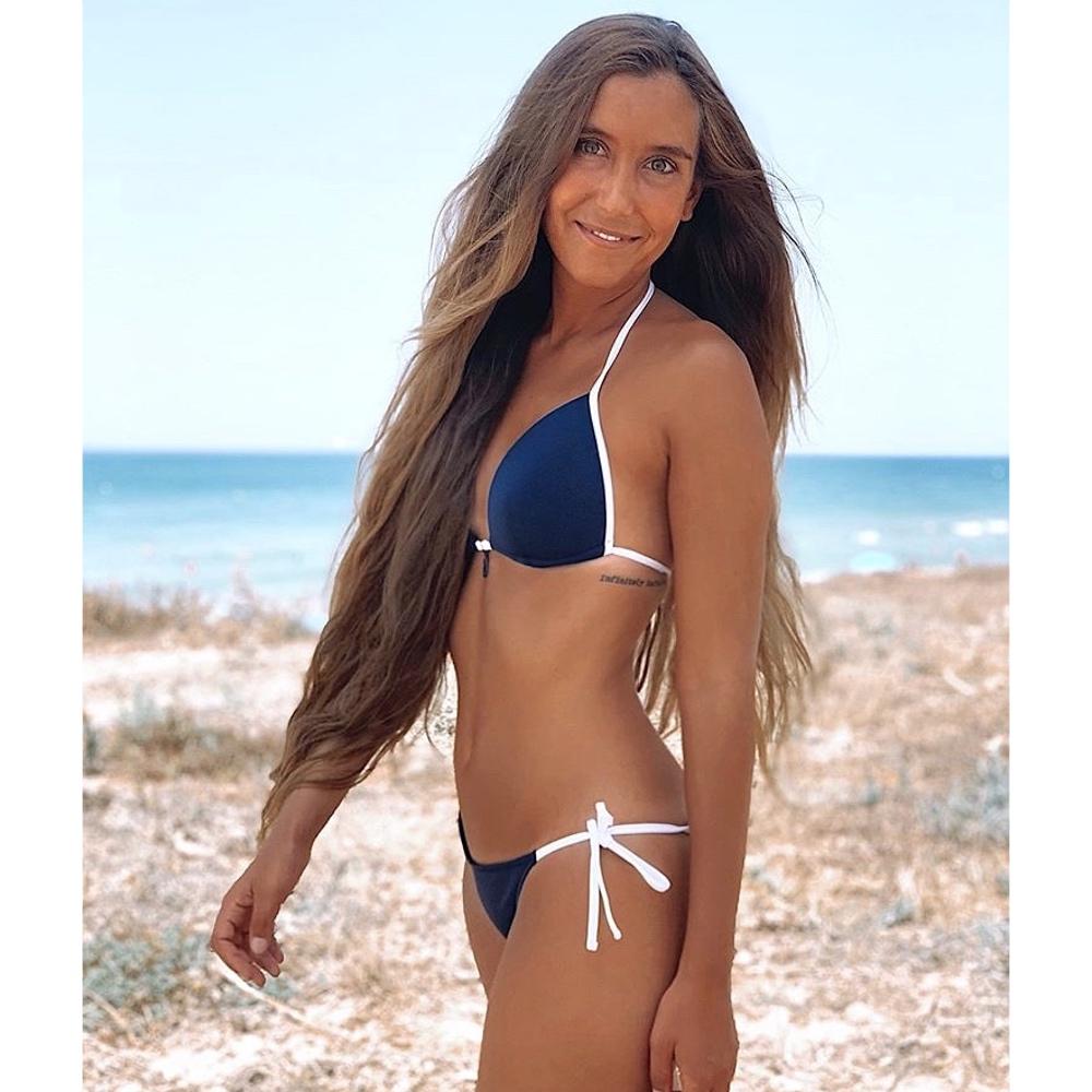 Totally adjustable navy blue bikini set with push-up bra and bottom. White straps and zipper detail. Really comfortable for pool or beach. This bikini will never upset you, it will alway be one of your favorites.